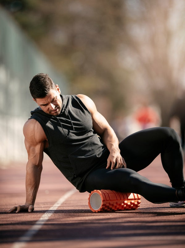 Athlete stretches using foam roller