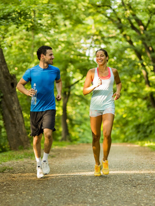 Young man and woman jogging in the park
