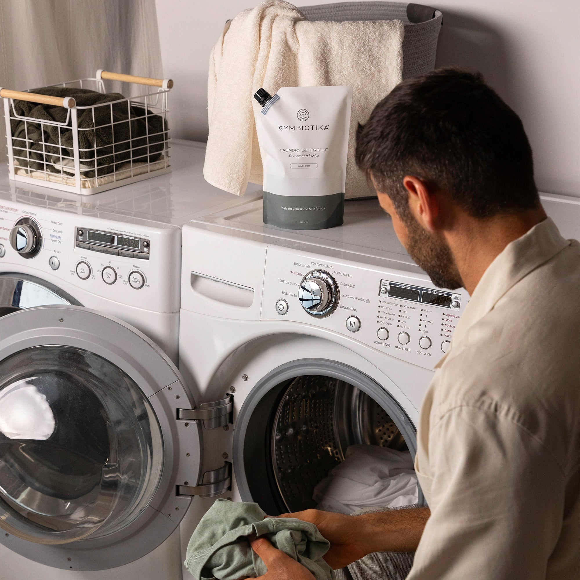 Man Putting Laundry Into Laundry Machine