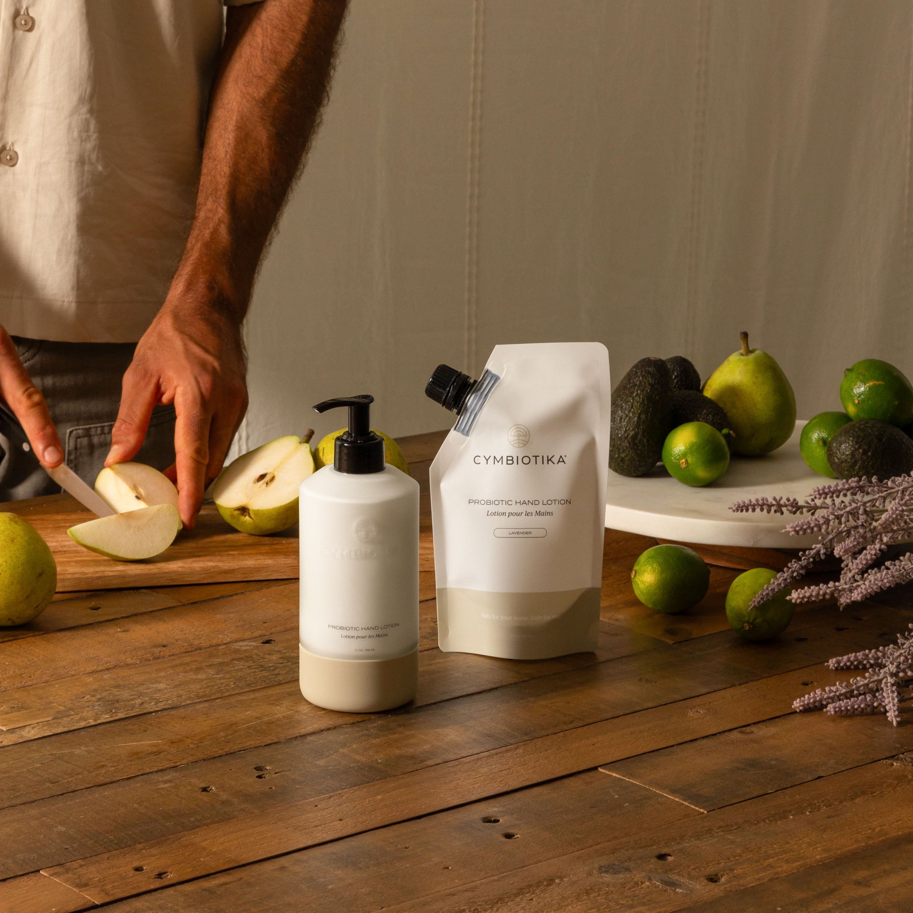 Probiotic Hand Lotion Kit on Counter next to Pear being Cut